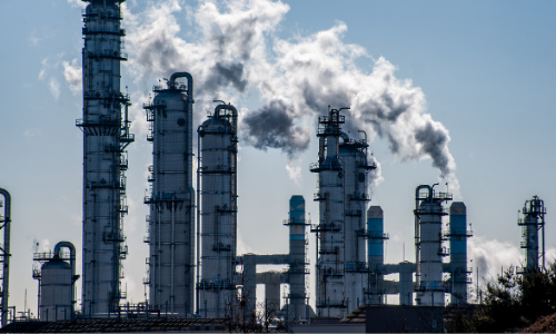Outdoor landscape view of tall gas pillars with steam coming out of the top.